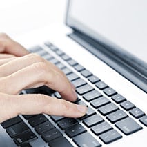 Typing on a laptop