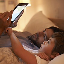 Man and boy using an iPad together